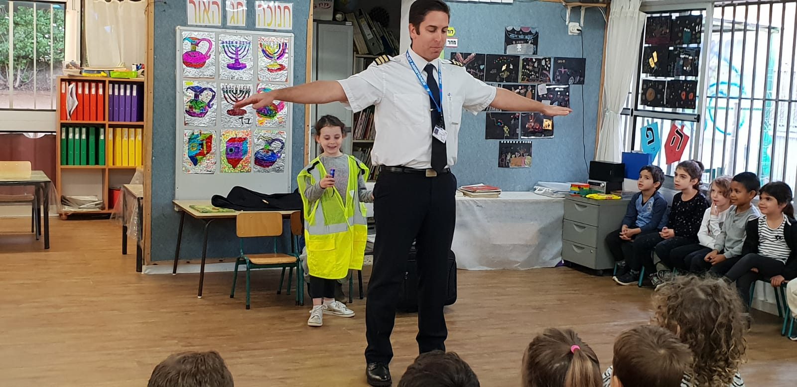 Elad speaking to a classroom in uniform