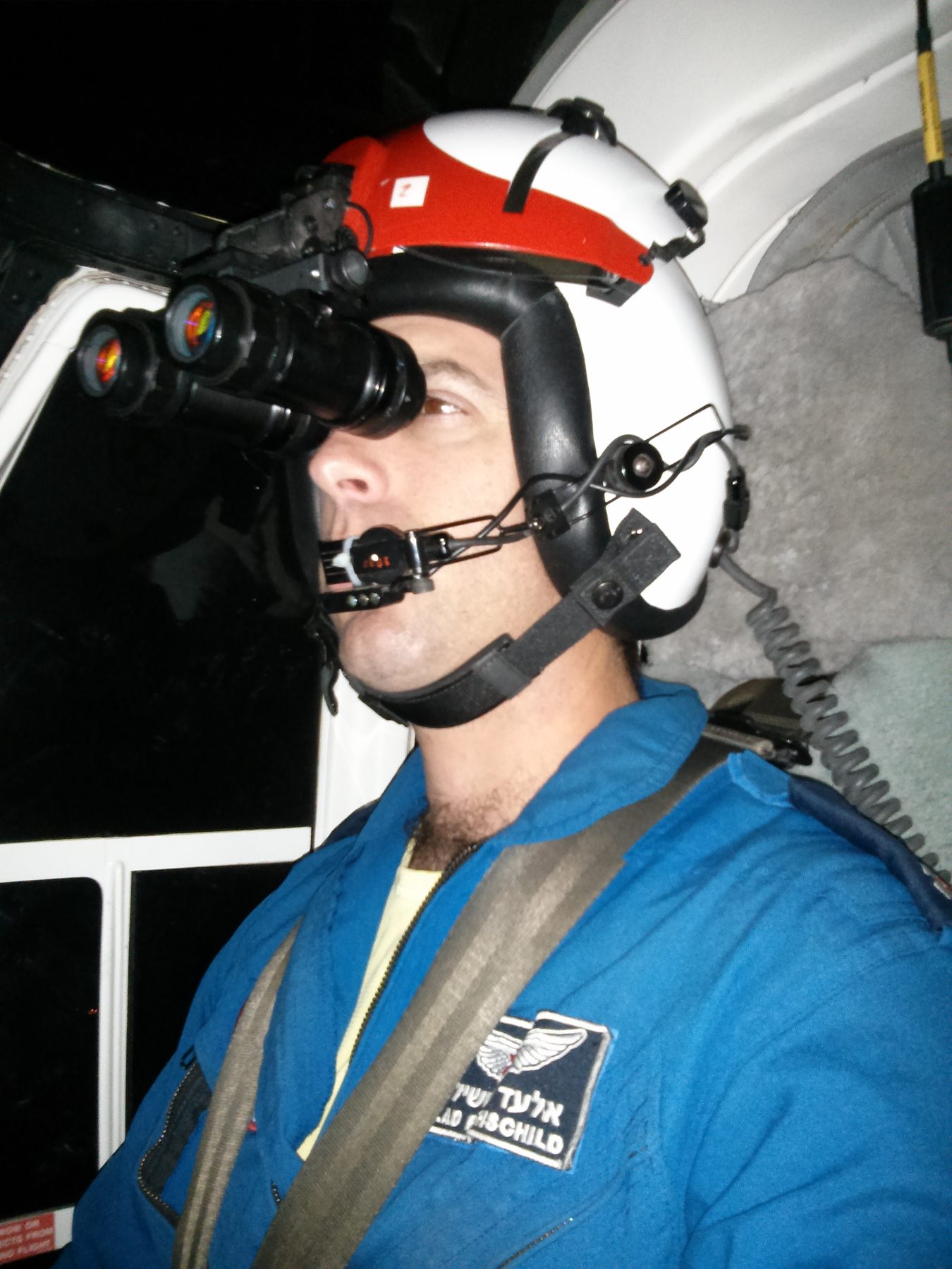 Elad wearing night vision goggles, name tag visible